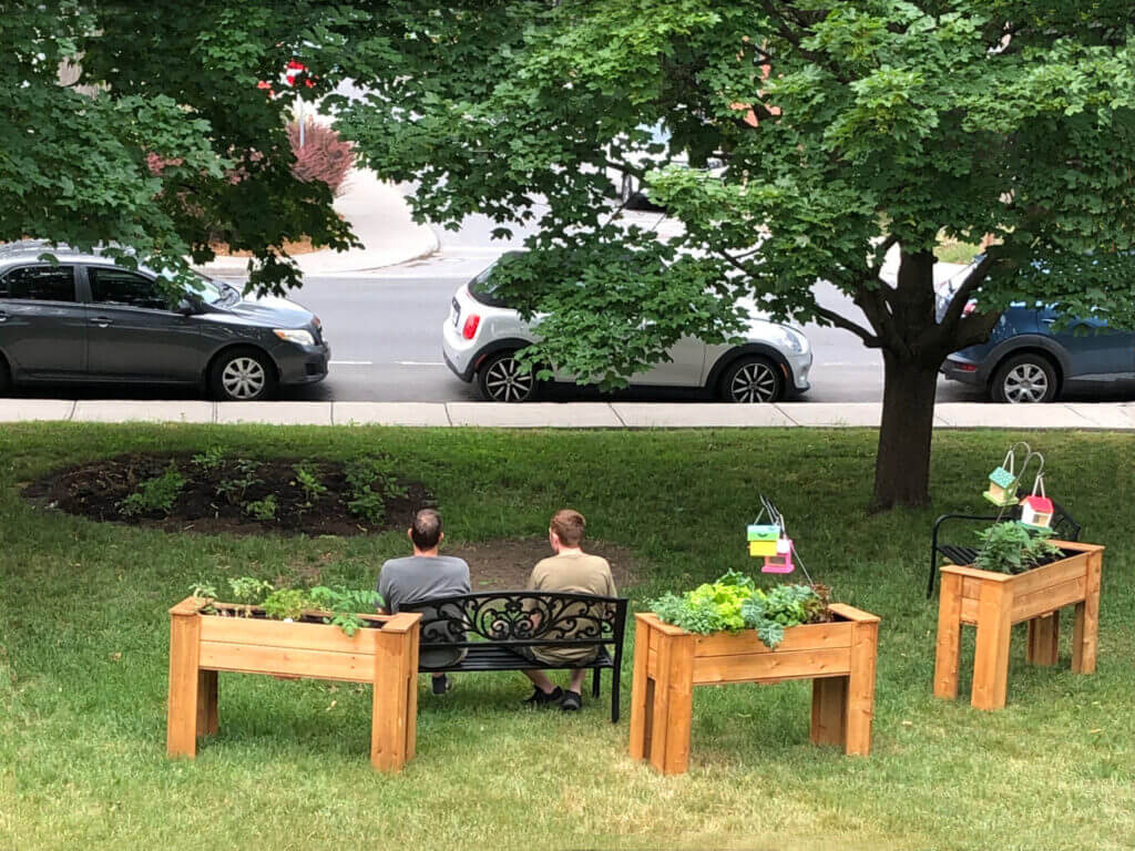 Our Harbour residents sitting on a bench in a park