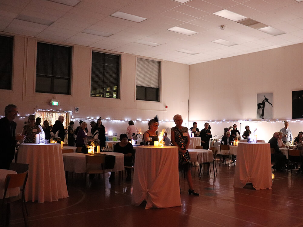 People listening to a speech at Our Harbour's 20th-anniversary gala