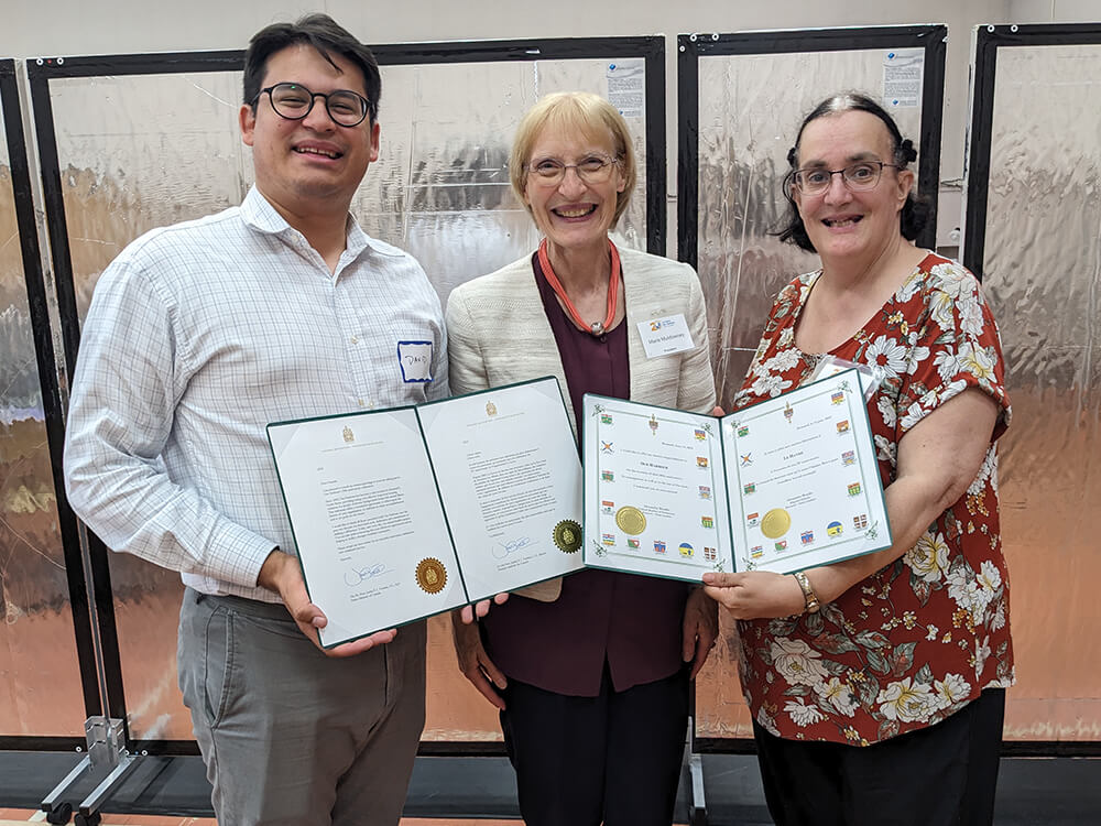 People holding certificates at Our Harbour's 2023 annual general meeting