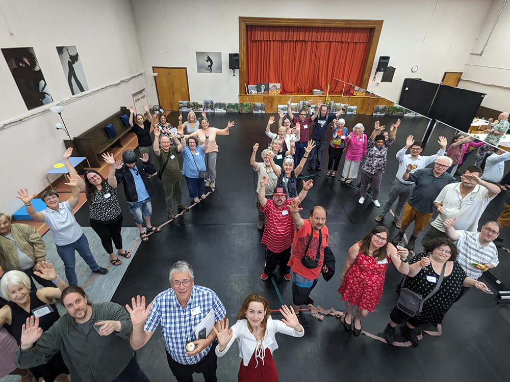 People posing in the shape of a 20 at the 2023 annual general meeting