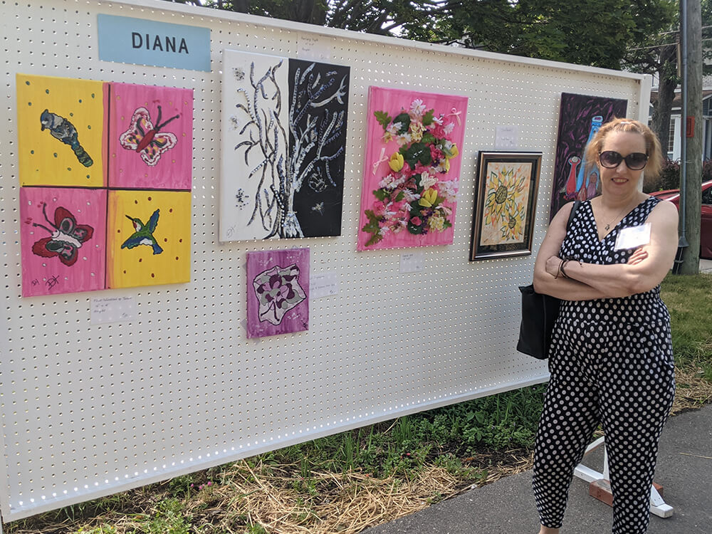 Diana with her art work at our 2023 art exhibit