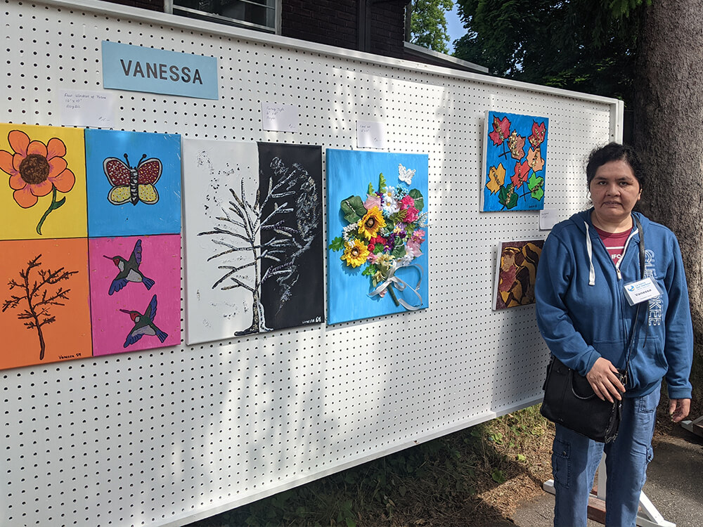 Vanessa with her art work at our 2023 art exhibit