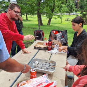 Image of our residents cooking some marshmallows in the park